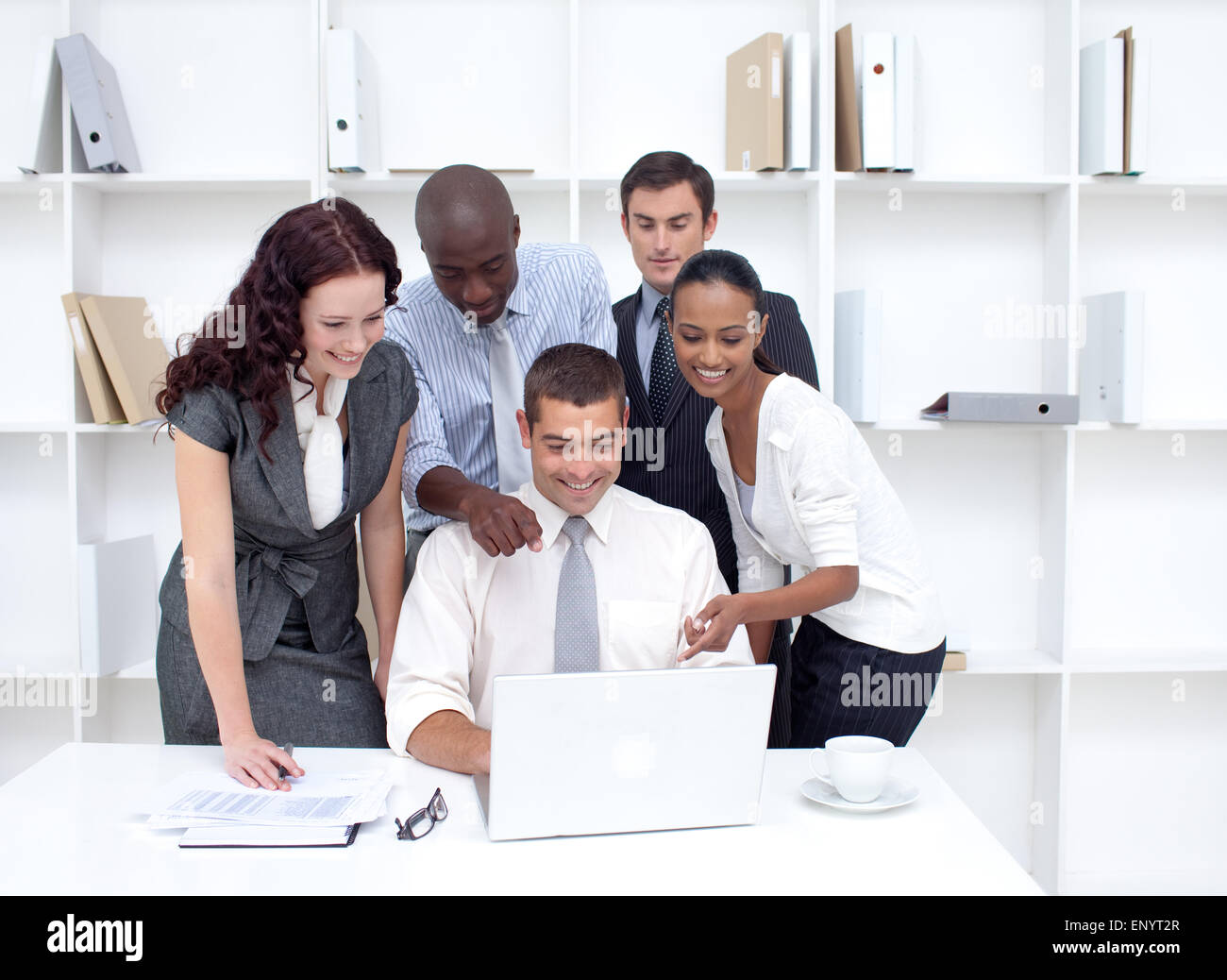 Business team working together with a laptop in office Stock Photo - Alamy