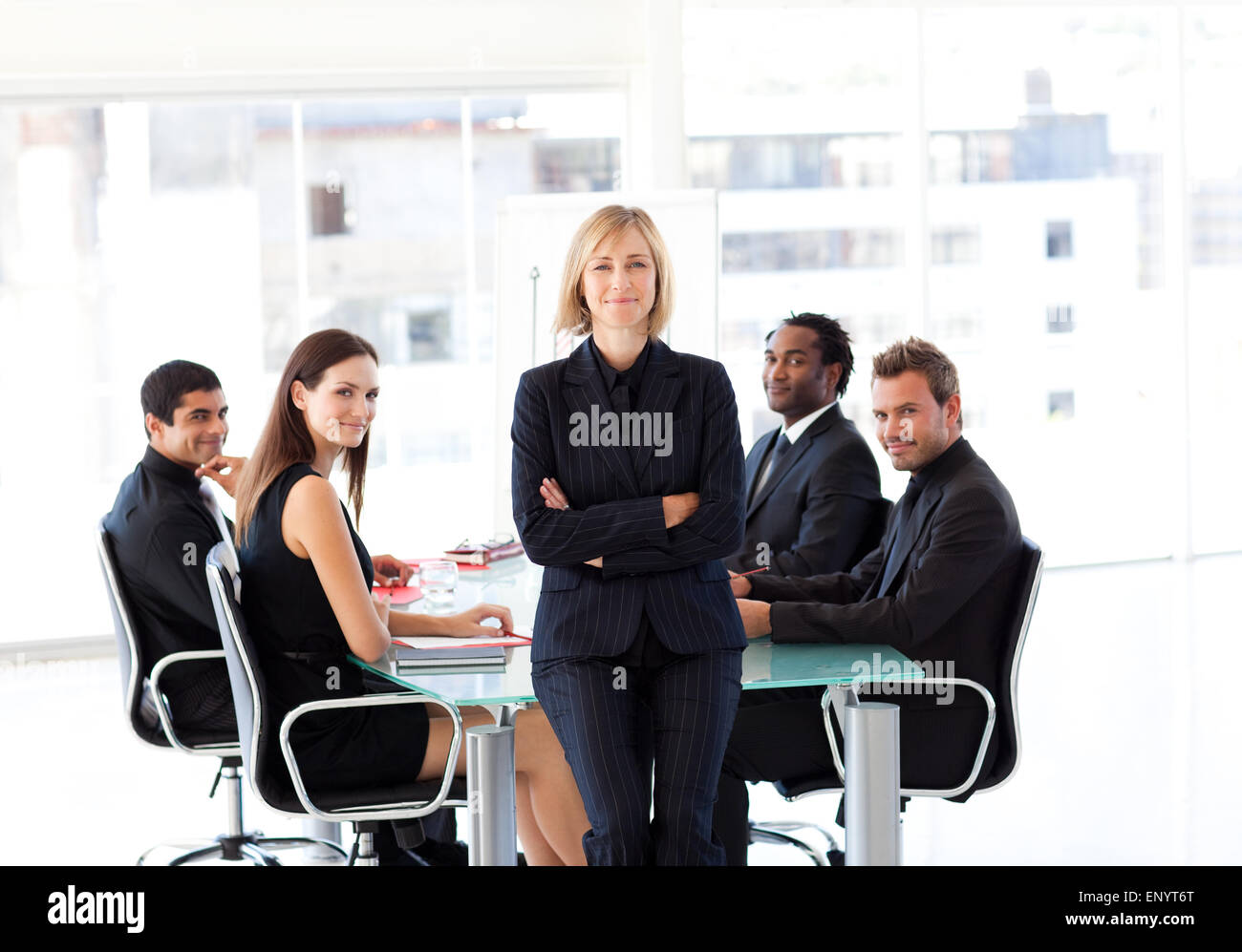Business team smiling at the camera in an office Stock Photo - Alamy
