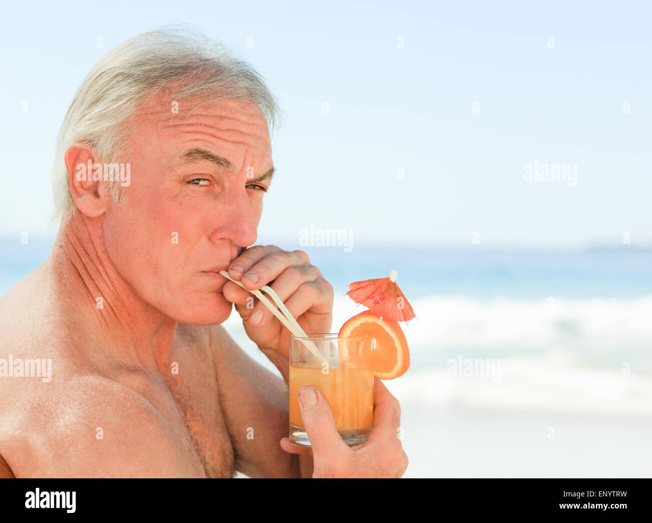 Retired man drinking cocktail beach hi-res stock photography and images ...