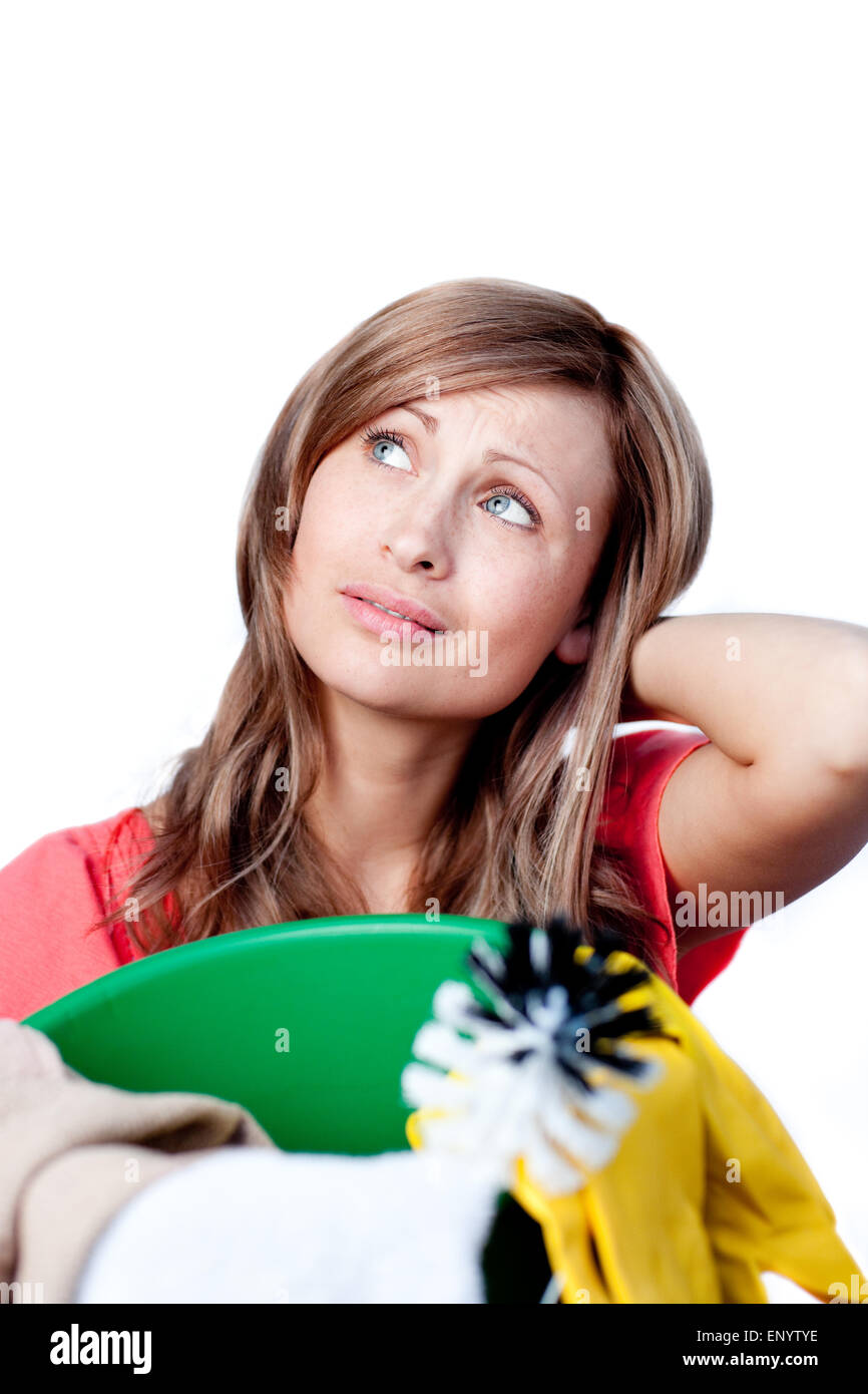 Portrait of a beautiful woman doing housework against a white ...
