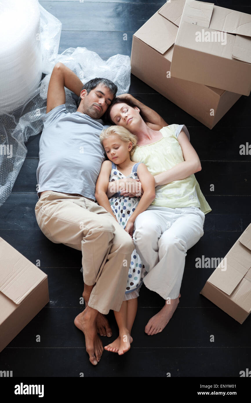 Famiy lying on floor after buying house Stock Photo