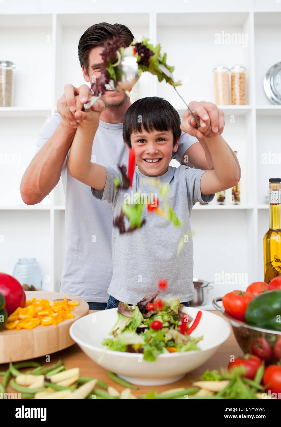 Portrait Of A Happy Father Preparing A Salad With His Son Stock Photo Portrait Of A Happy Father Preparing A Salad With His Son Stock Photo