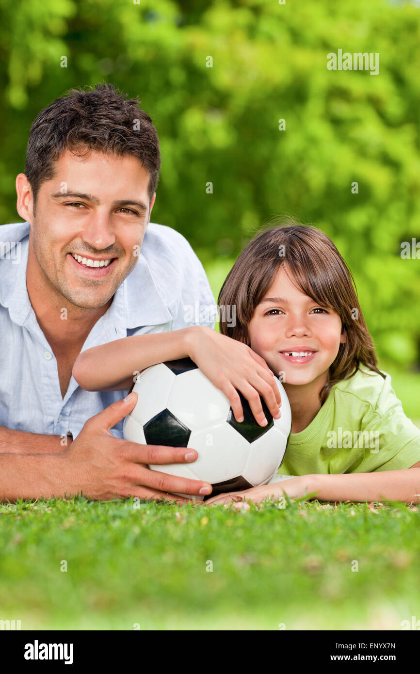 Father and his son with their ball in the park Stock Photo Alamy