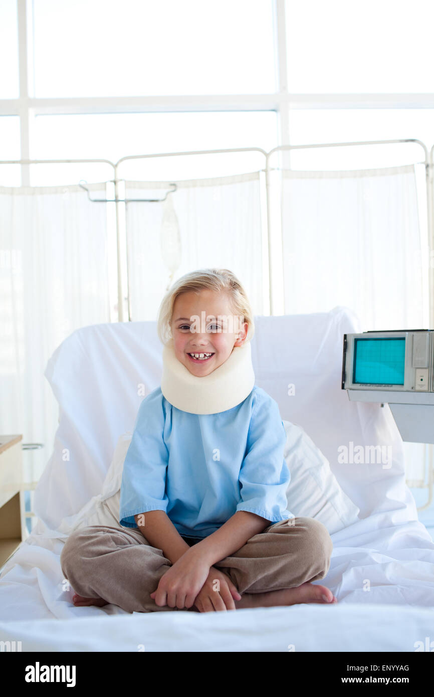 Smiling girl sitting on a hospital bed Stock Photo - Alamy
