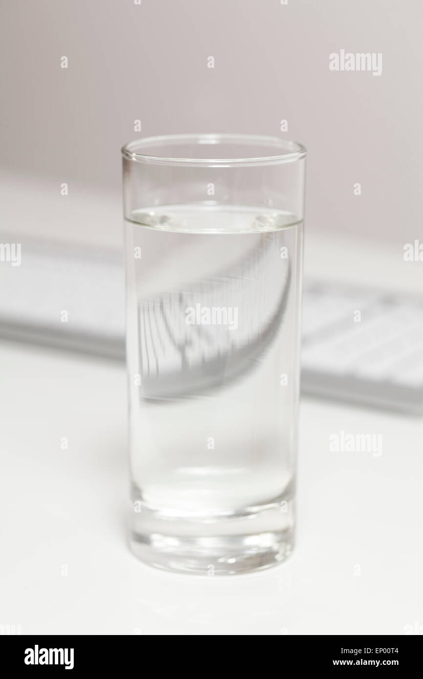 Glass of water on desk Stock Photo Alamy