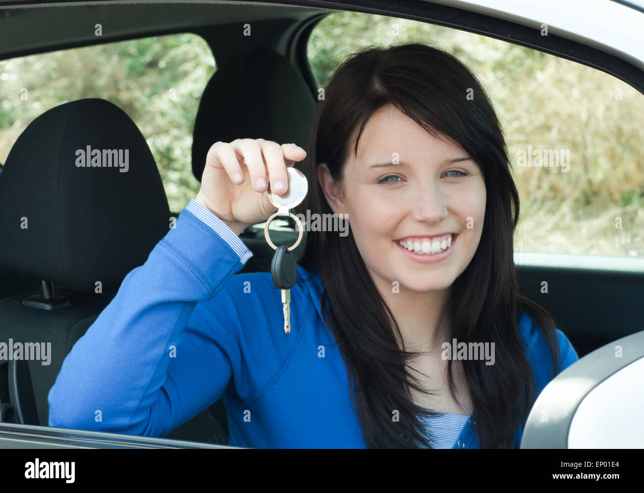 Radiant teenager holding car keys sitting in her new car Stock Photo Alamy
