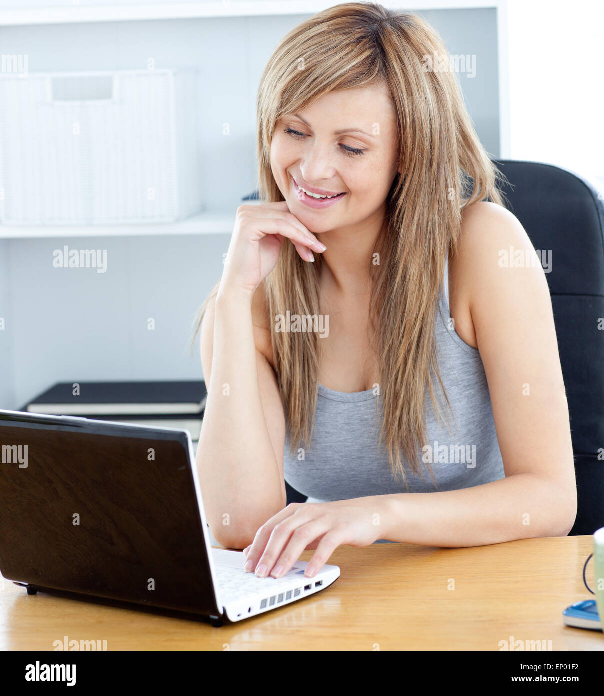 Beautiful woman using her laptop at home Stock Photo - Alamy