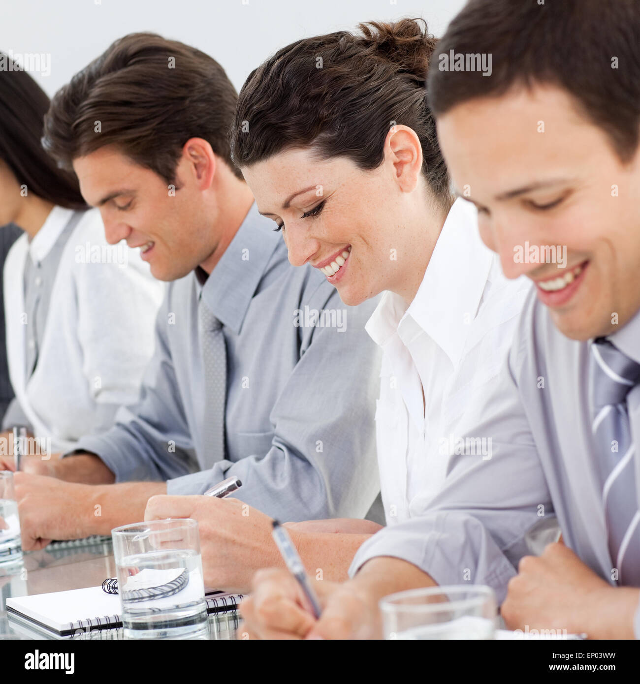 Young business people taking notes at a conference Stock Photo - Alamy