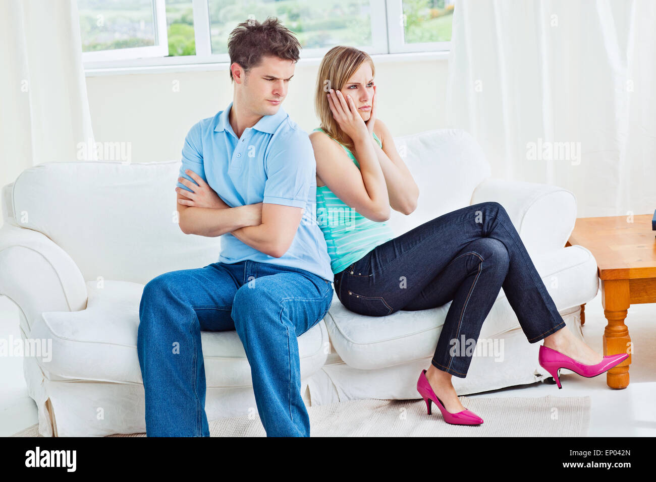Angry couple sitting on the sofa back to back after a quarrel Stock ...