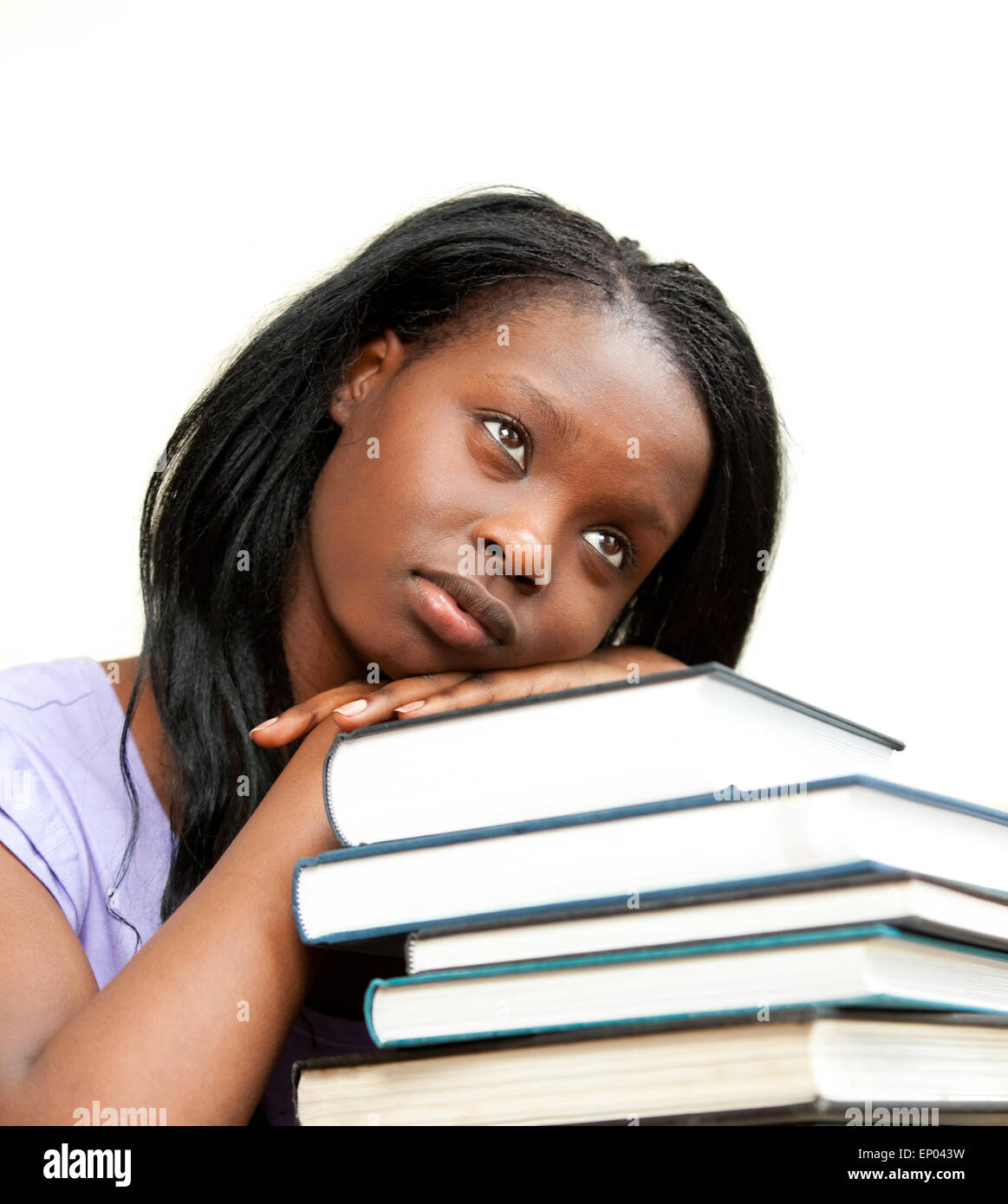 Student leaning on a stack of books Stock Photo - Alamy