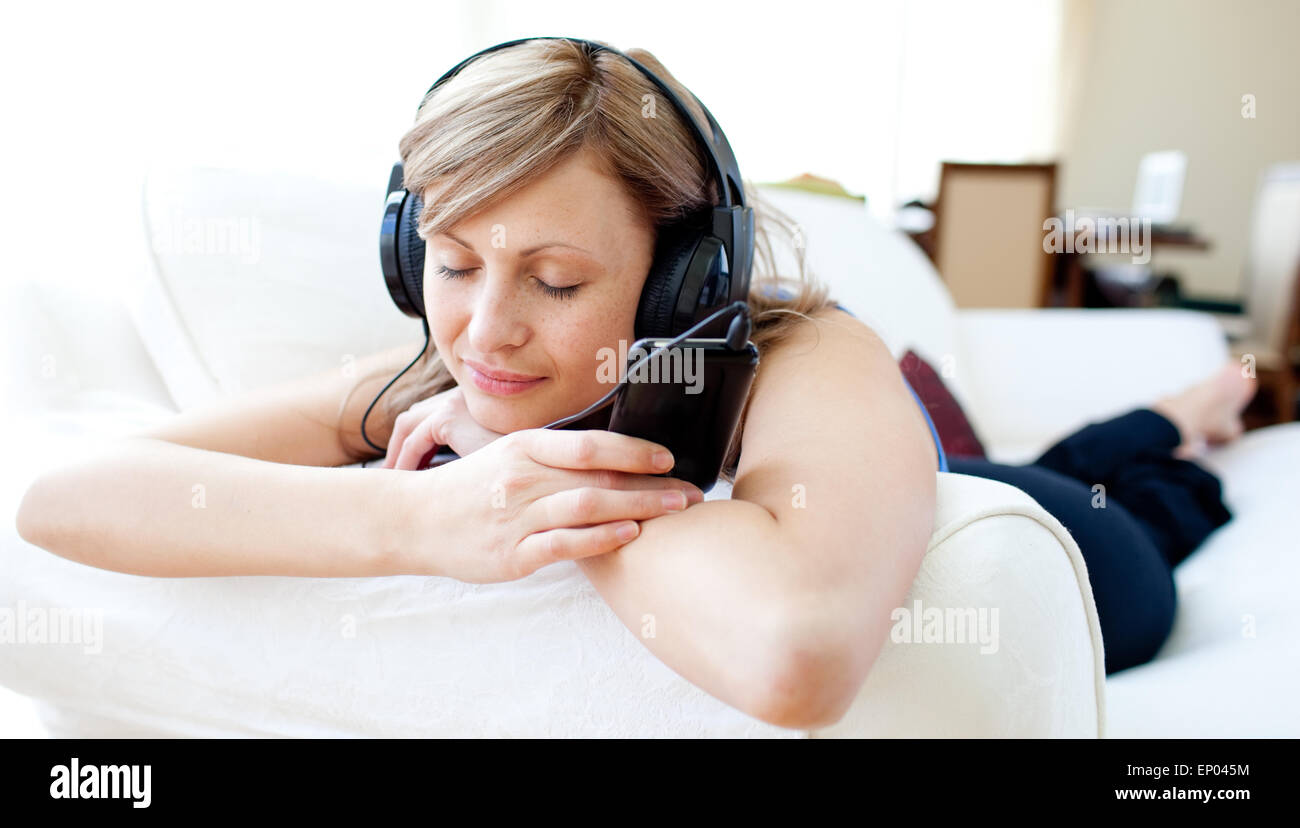 Portrait of a bright woman listening the music with headphones Stock Photo