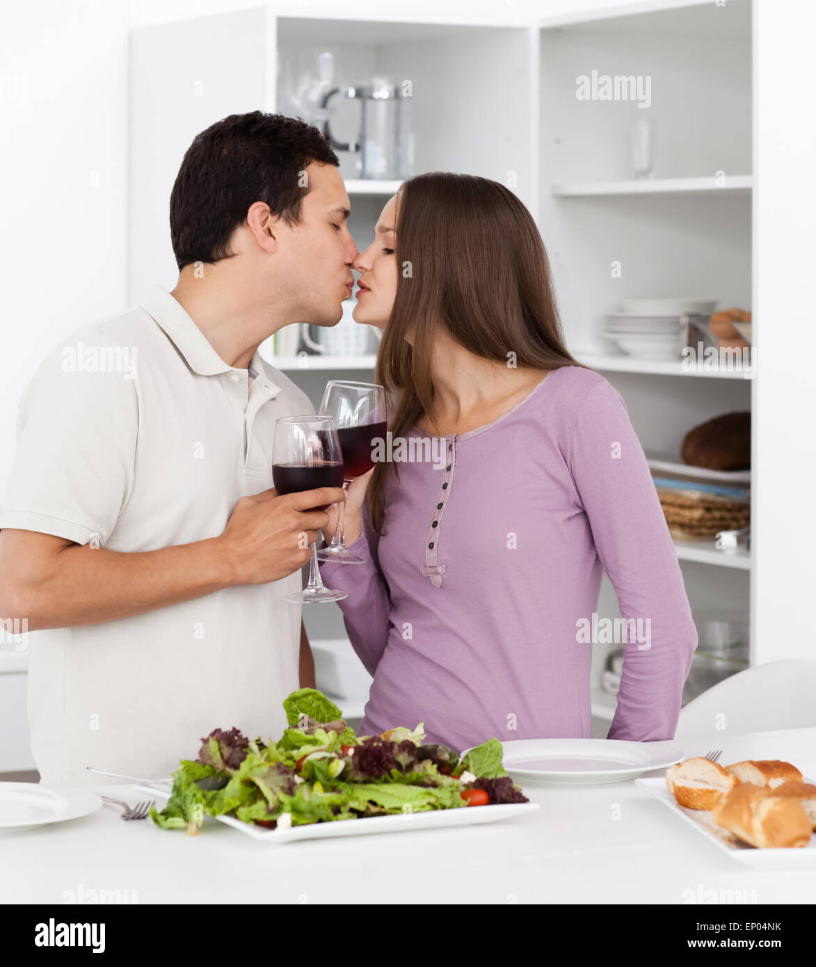 Cute couple kissing while having lunch in the kitchen Stock Photo Alamy