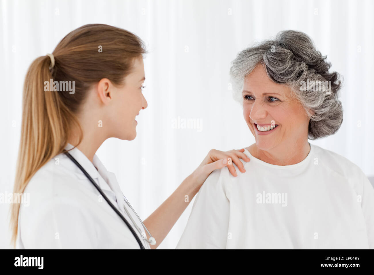 Patient with her nurse smiling Stock Photo - Alamy