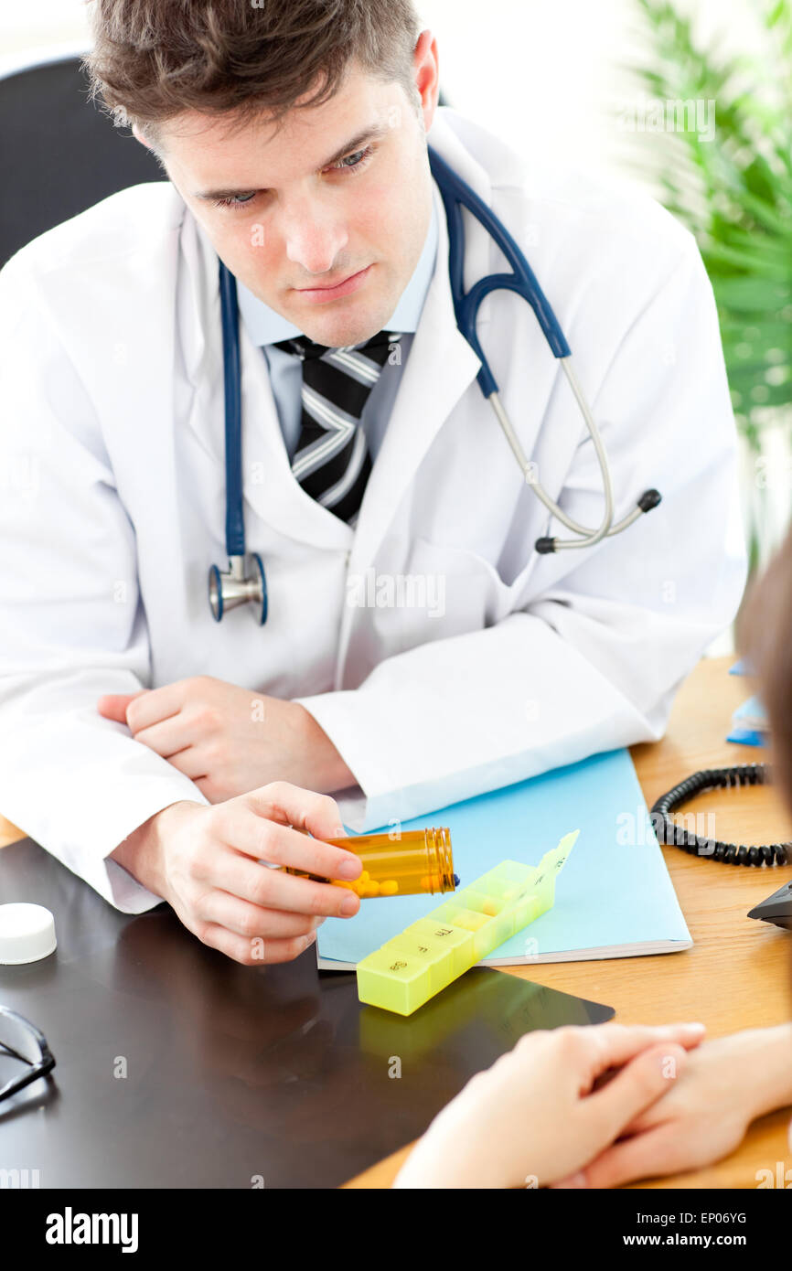 Assertive male doctor giving pills to his patient Stock Photo - Alamy