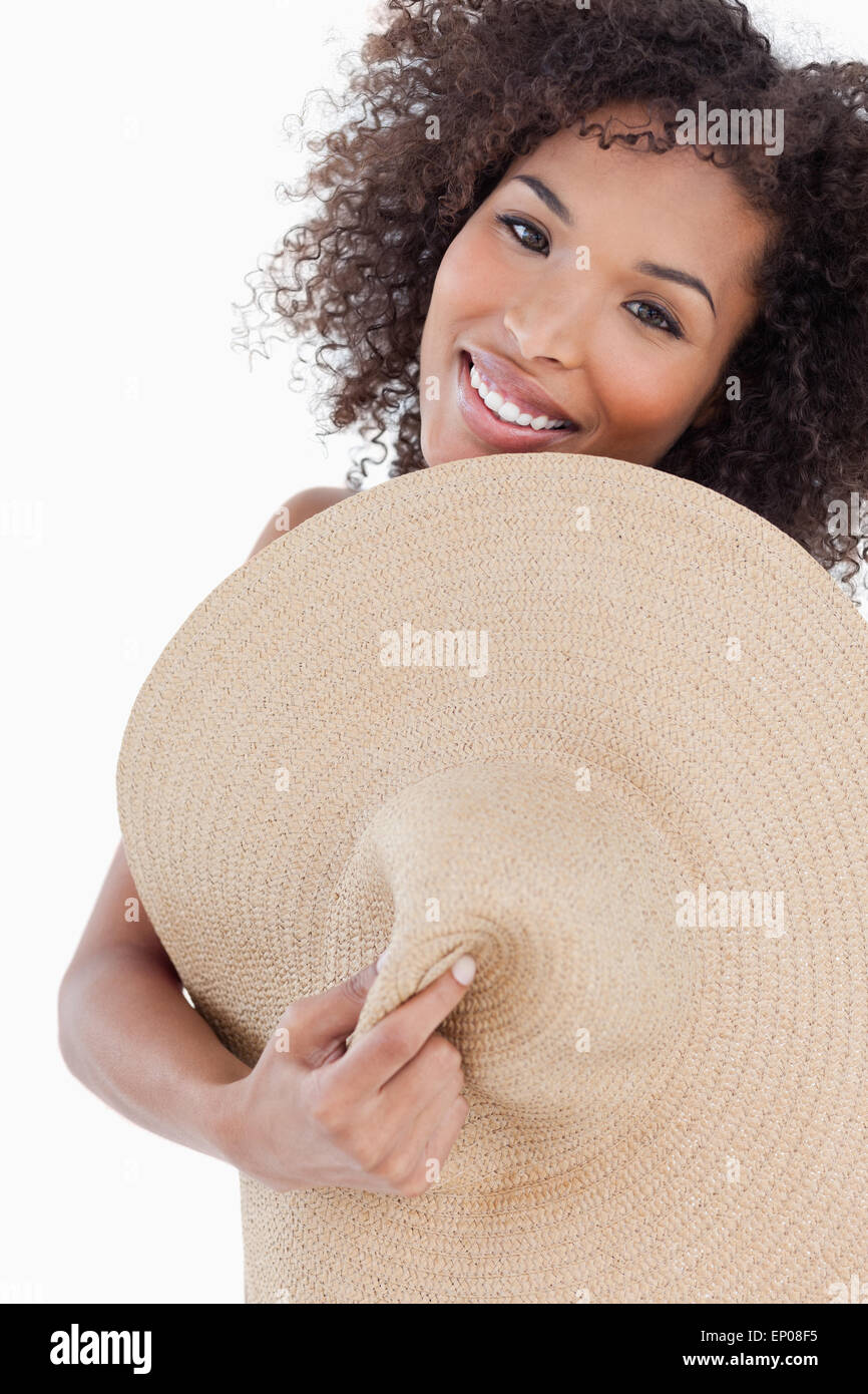 Young woman hiding her body behind a straw hat Stock Photo - Alamy