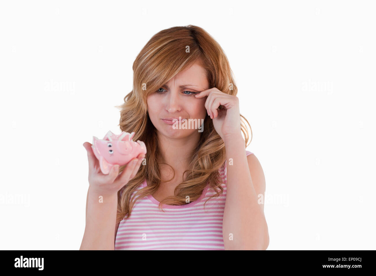 Blond-haired woman crying while holding her broken piggybank Stock ...