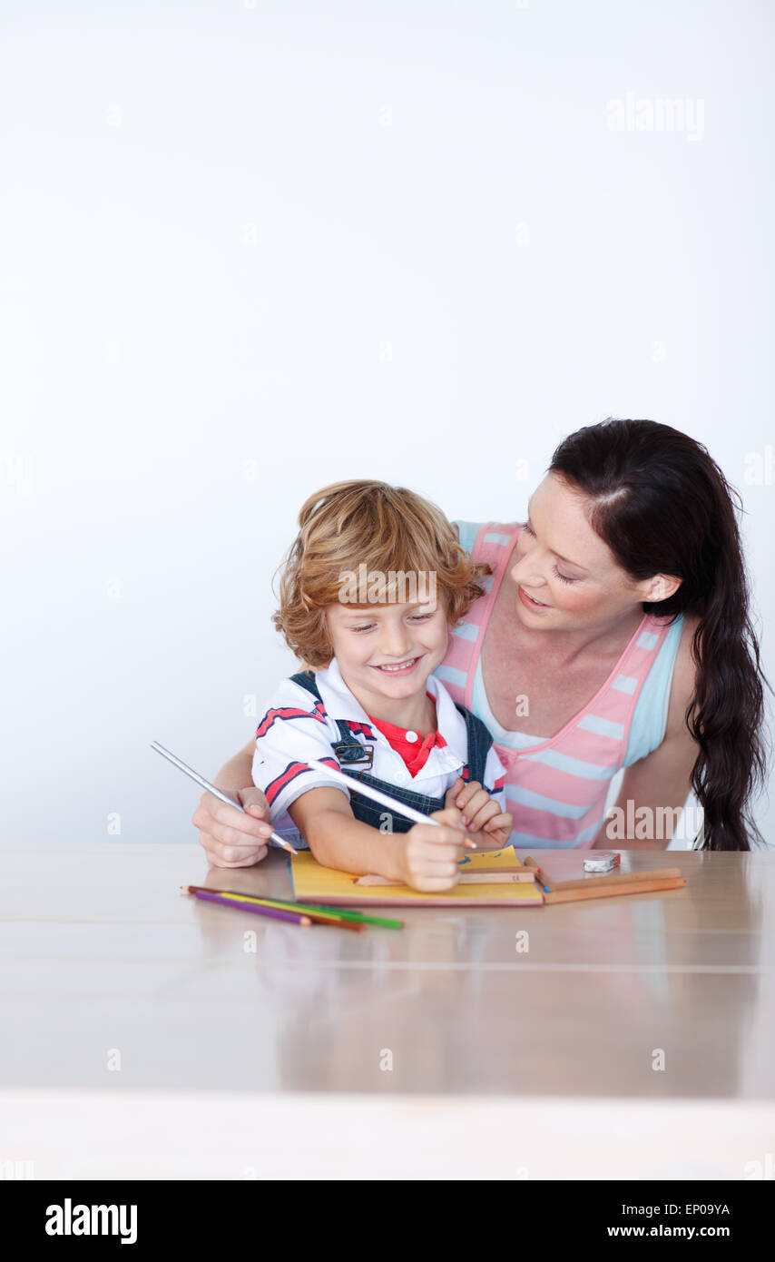 Loving mother help his son to draw a picture Stock Photo - Alamy