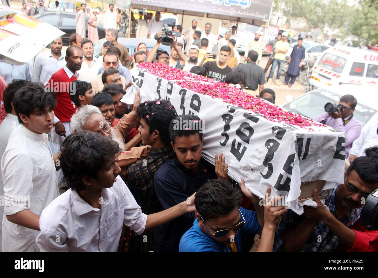Relatives of Former Muttahida Qaumi Movement (MQM) activist Saulat Mirza carry his dead body to shift an Edhi cold storage who was hanged at Mach prison on Tuesday in triple murder case was stated to be calm and composed at gallows, in Karachi on Tuesday, May 12, 2015. Former Muttahida Qaumi Movement (MQM) activist Saulat Mirza was executed today morning at 4:30 AM, for the murder of former KESC managing director Shahid Hamid, his driver and guard in 1997. Stock Photo