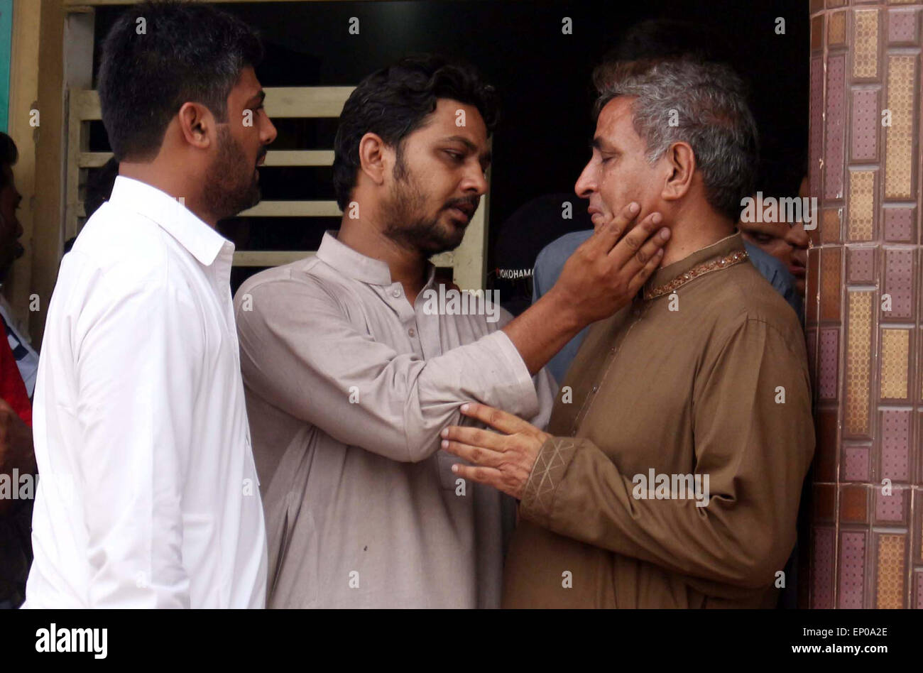 Relatives of Former Muttahida Qaumi Movement (MQM) activist Saulat Mirza react mourn on the shifting of his dead body, who was hanged at Mach prison on Tuesday in triple murder case was stated to be calm and composed at gallows, at Edhi cold storage in Karachi on Tuesday, May 12, 2015. Former Muttahida Qaumi Movement (MQM) activist Saulat Mirza was executed today morning at 4:30 AM, for the murder of former KESC managing director Shahid Hamid, his driver and guard in 1997. Stock Photo