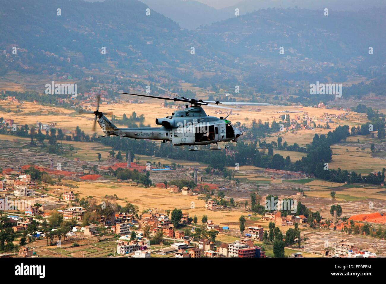 Kathmandu, Nepal. 10th May, 2015. A U.S. Marine Corps UH-1Y Venom from Joint Task Force 505 flies relief supplies following massive earthquakes that struck the mountain kingdom May 9, 2014 in Sindhuli District, Nepal. Stock Photo
