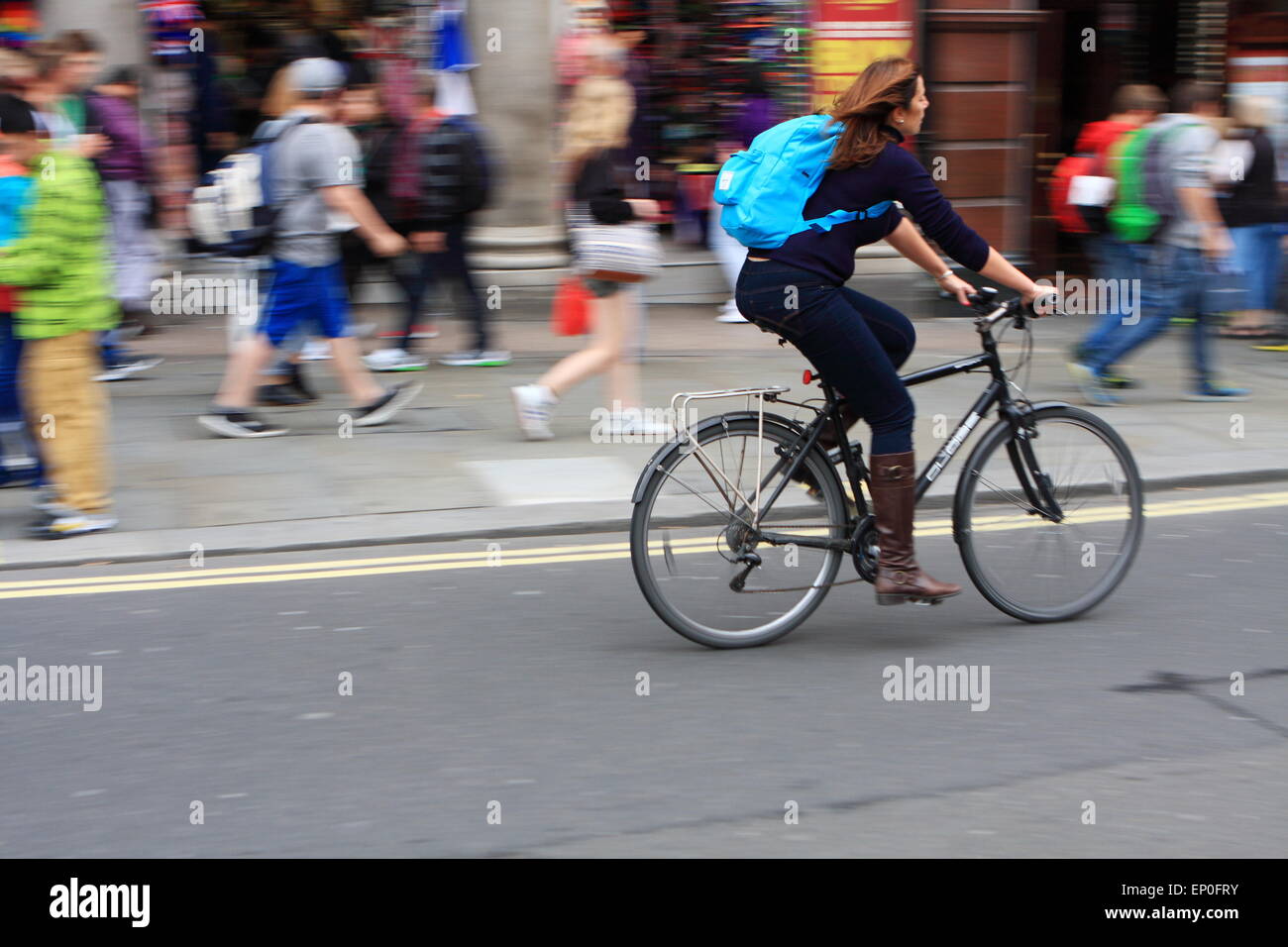 Cyclist traveling along a road in London, England Stock Photo