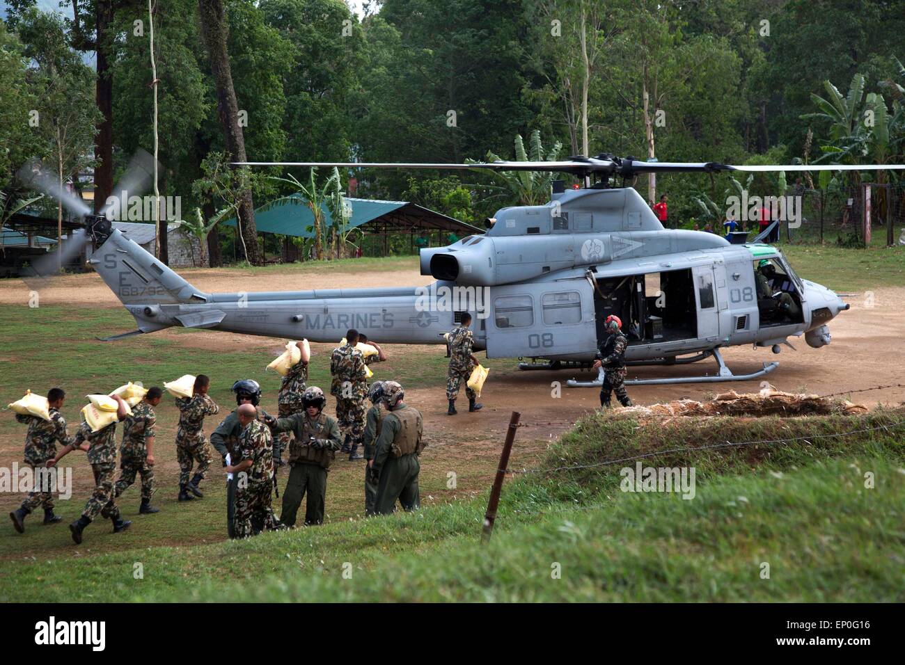 Kathmandu, Nepal. 10th May, 2015. Nepalese soldiers load relief supplies into a U.S. Marine Corps UH-1Y Venom helicopter following massive earthquakes that struck the mountain kingdom May 11, 2014 in Sindhuli, Nepal. Stock Photo