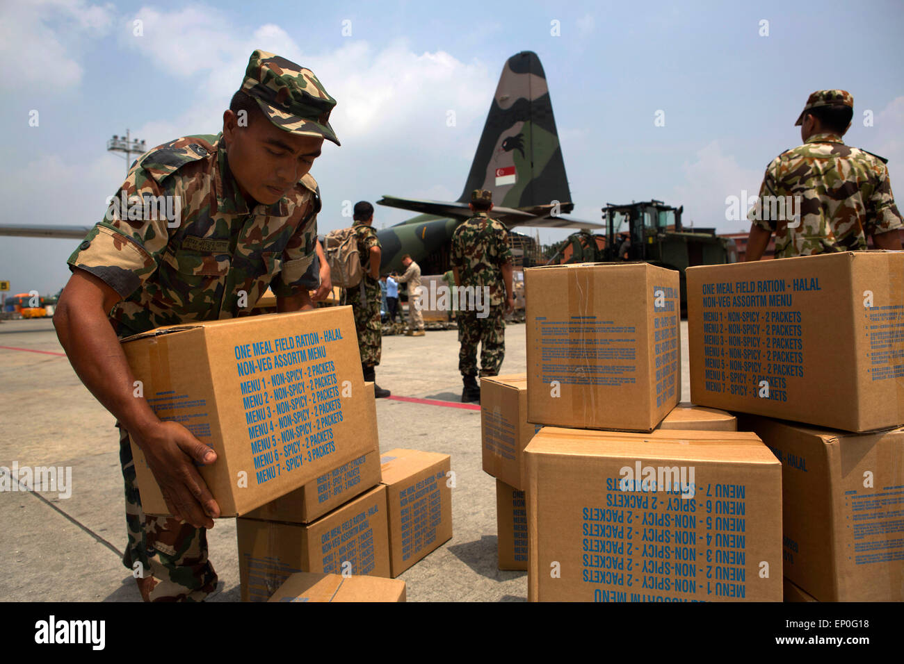 Kathmandu, Nepal. 10th May, 2015. Nepalese soldiers offload relief supplies at Tribhuvan International Airport following massive earthquakes that struck the mountain kingdom May 10, 2014 in Kathmandu, Nepal. Stock Photo