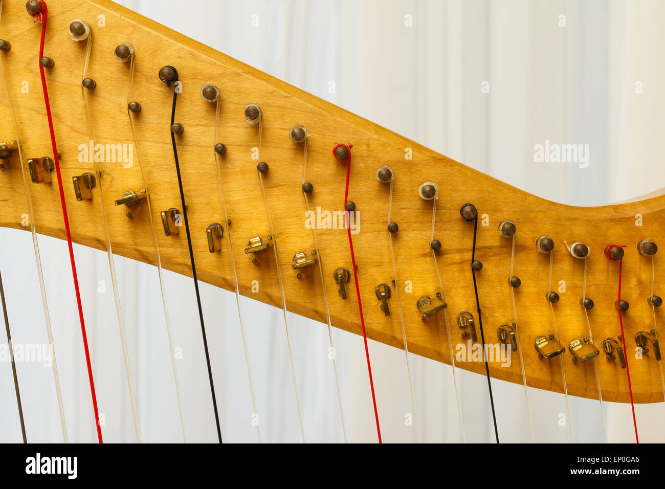 Close up of Celtic harp strings in red, black and transparent. Stock Photo