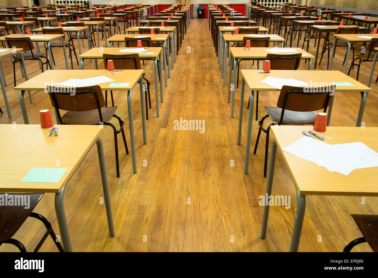 rows of tables and chairs with paper and cups waiting for the exam at highschool Stock Photo Alamy