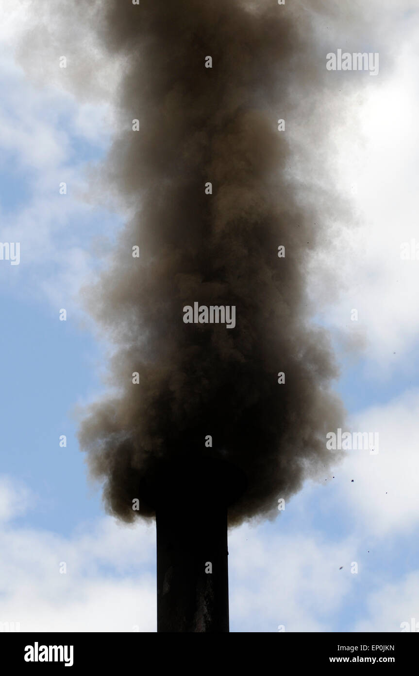 Smoking chimney of a coal fire exhaust fumes waste gas Stock Photo