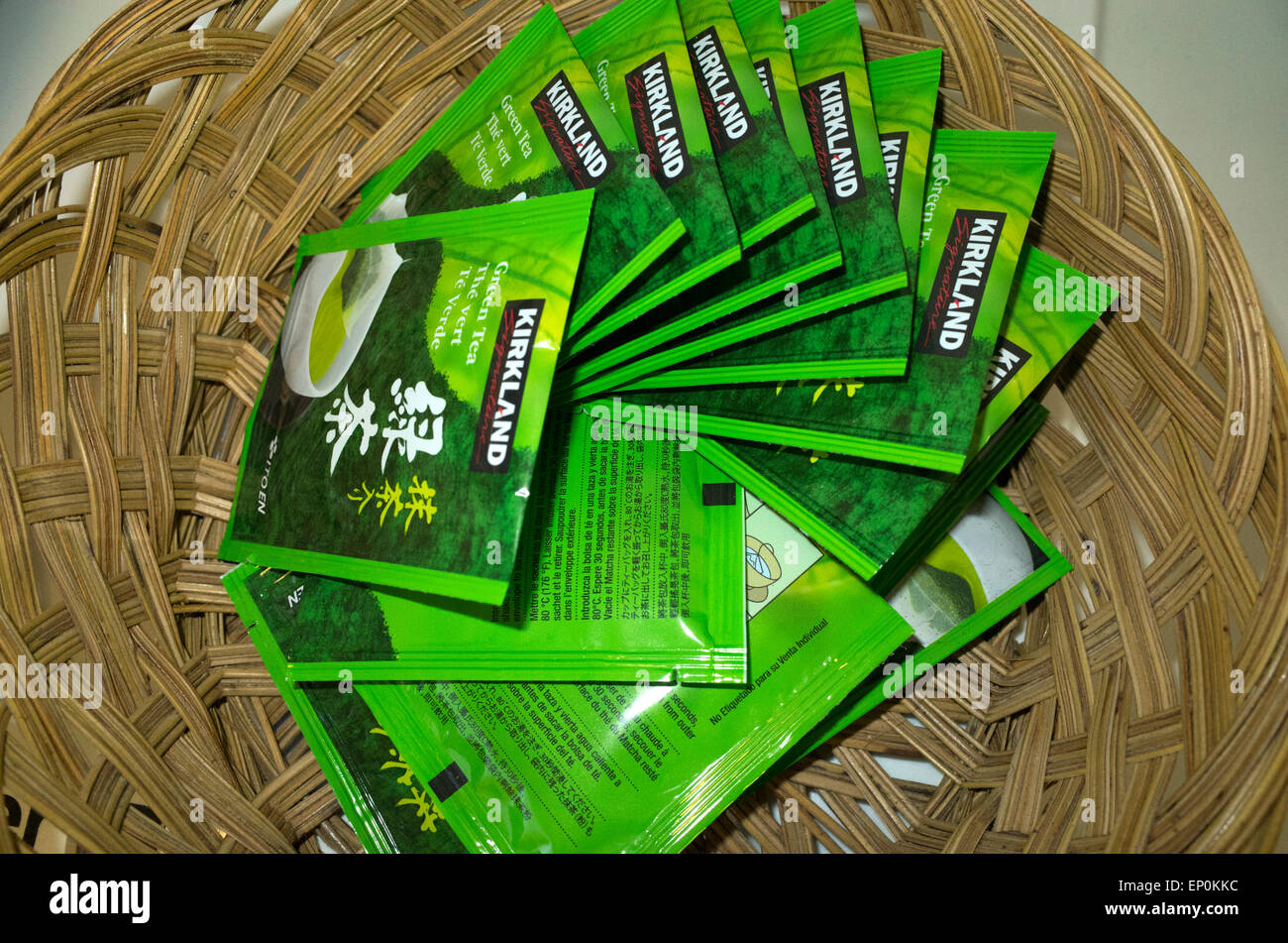 A spiral array of Kirkland Green Tea packets in a woven basket. St Paul