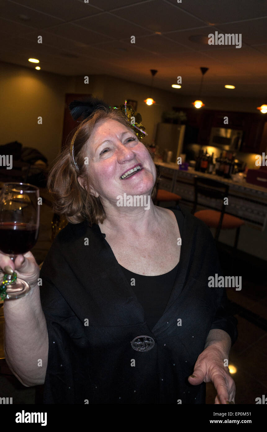 Ecstatic mature adult female enjoying a glorious moment at her Academy Award Party. St Louis Park Minnesota MN USA Stock Photo