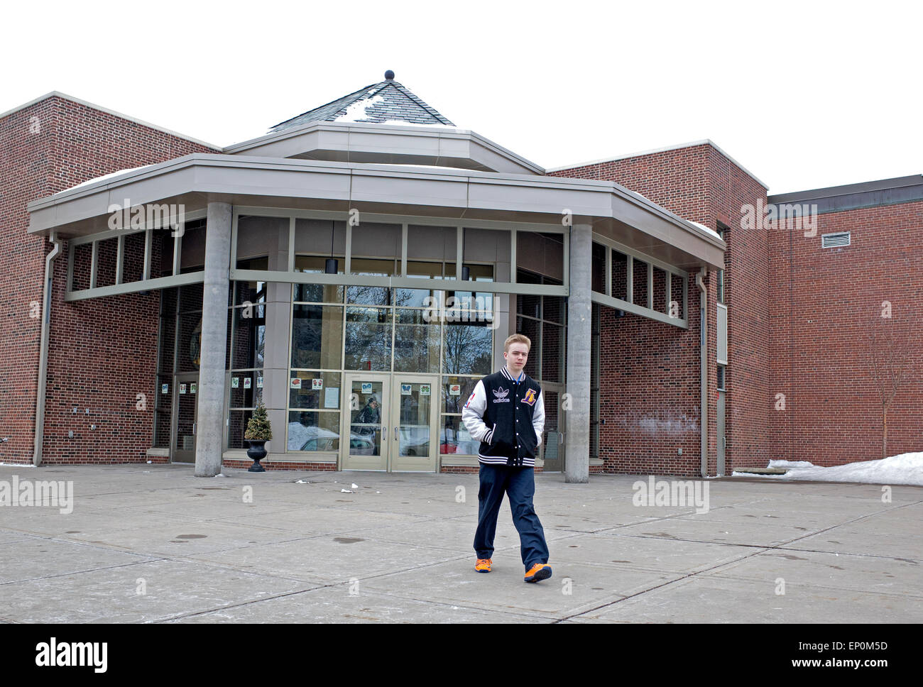 Teen male student age 14 walking from his school Nativity of Our Lord