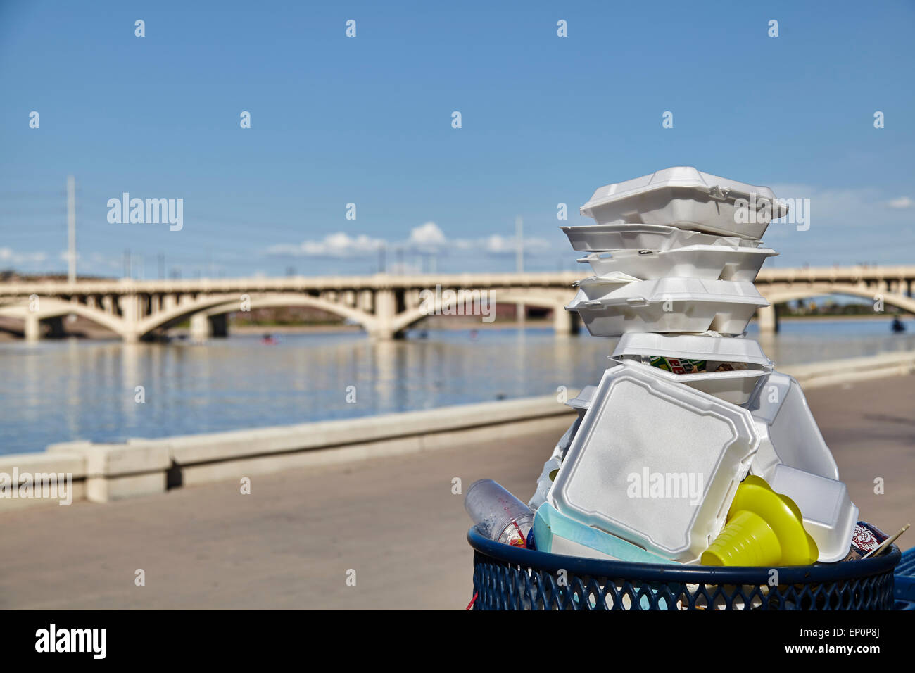 White styrofoam used food containers stacked in trash can in park Stock