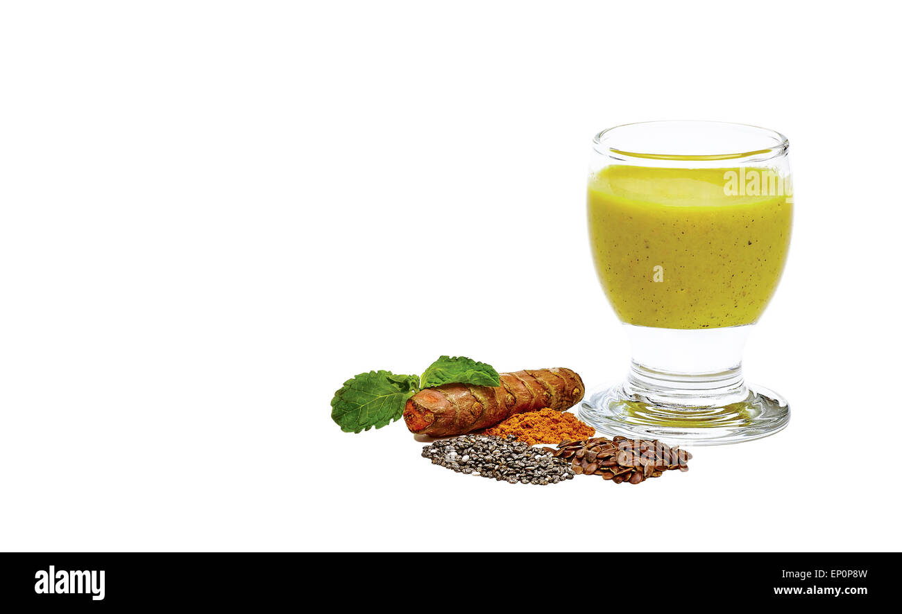 Tumeric root with smoothie made out of tumeric, coconut, chia seed