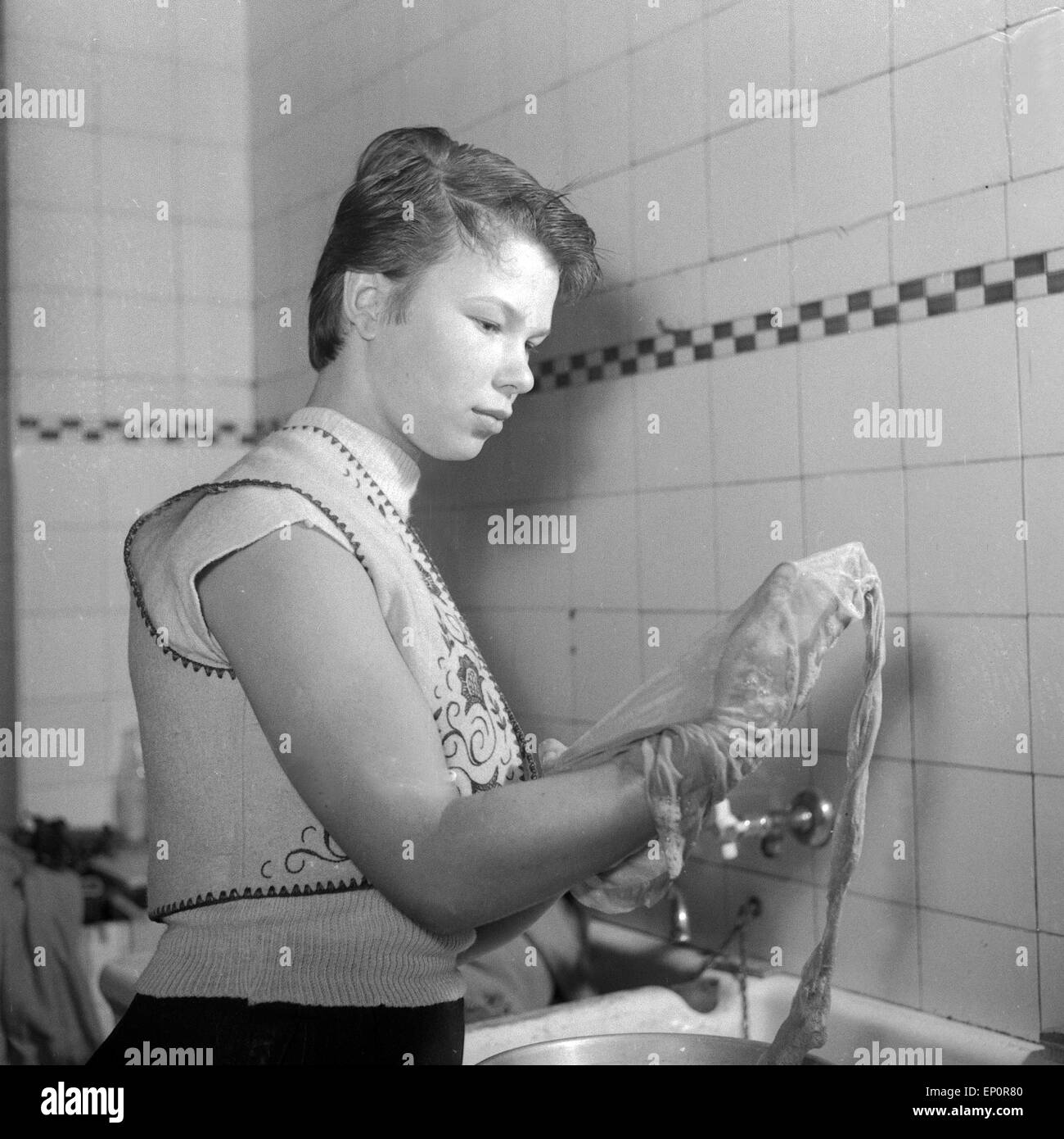 Eine junge Frau bei der Handwäsche einer Strumpfhose, Hamburg 1955. A young woman washing her stockings, Hamburg 1955. Stock Photo