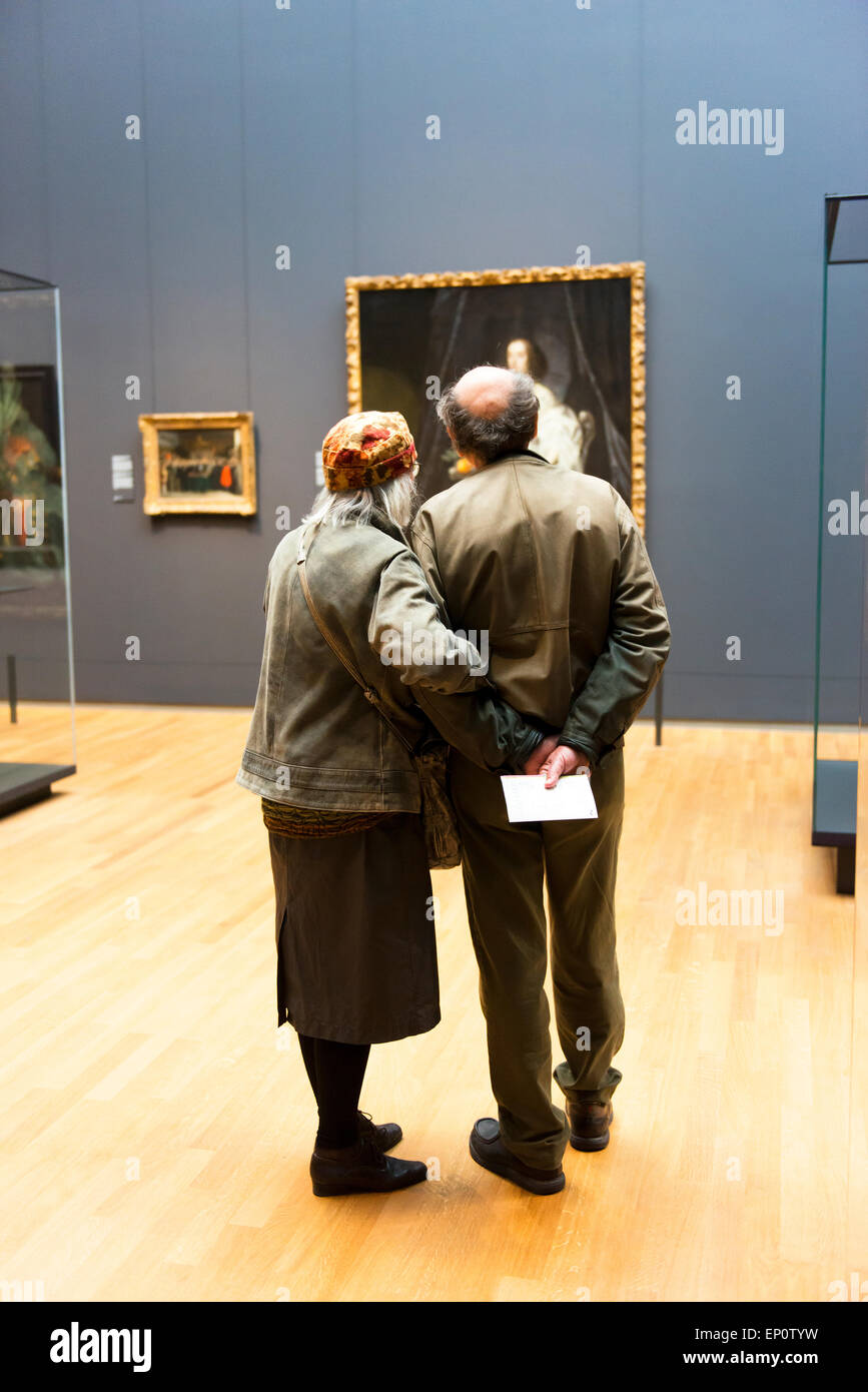 An affectionate elderly couple enjoy art displays in Amsterdam's Rijksmuseum. Stock Photo