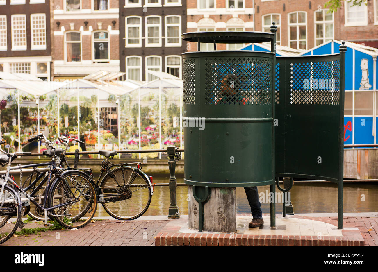 Urinal in use in Amsterdam's Old Town. Stock Photo