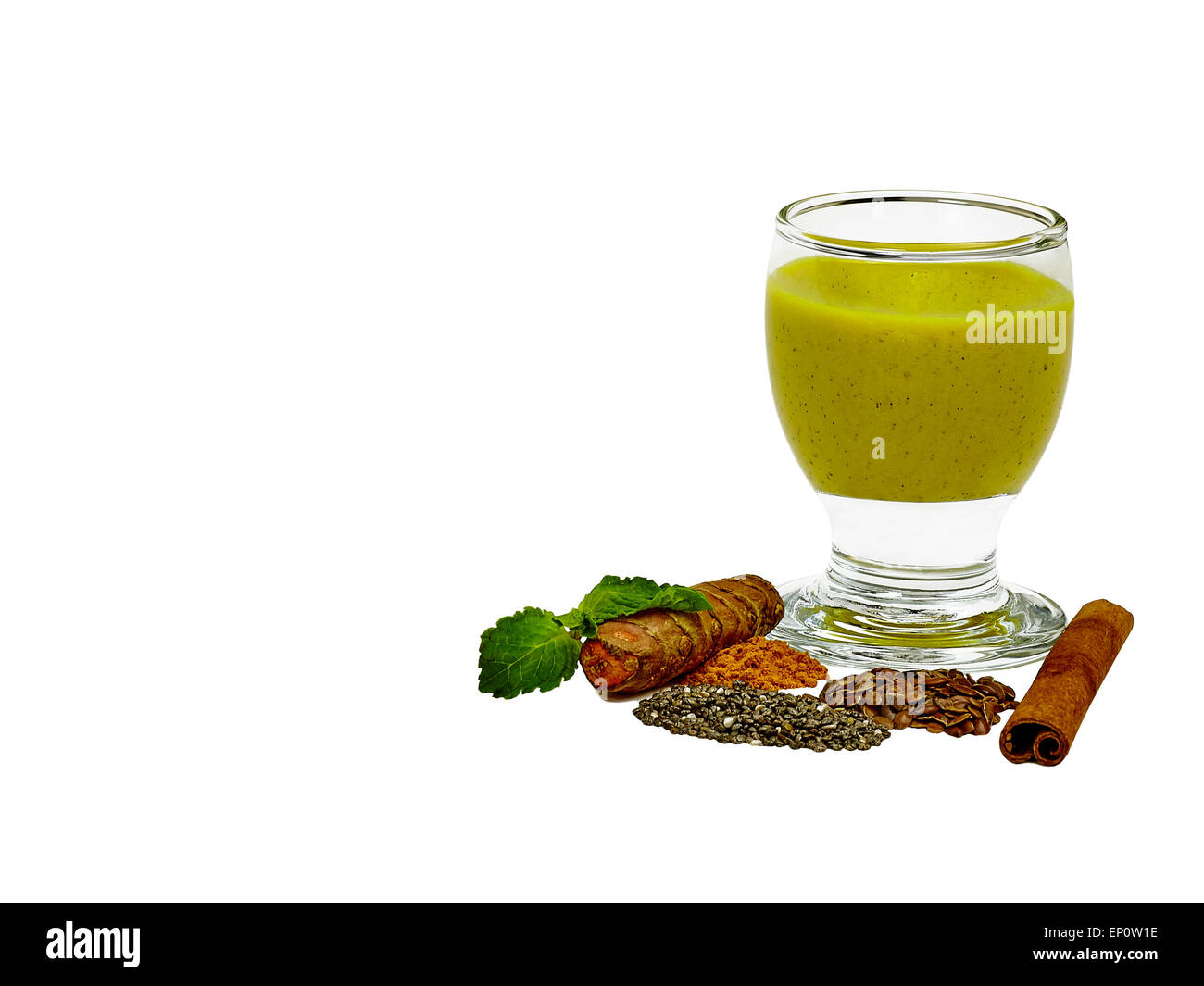 Tumeric root with smoothie made out of tumeric, coconut, chia seed