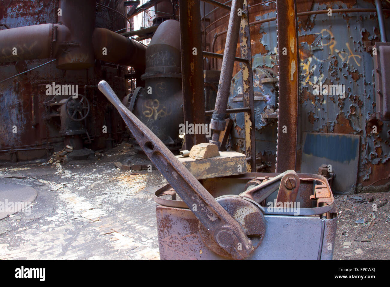 Rusting tools and equipment in abandoned steel mill. Stock Photo