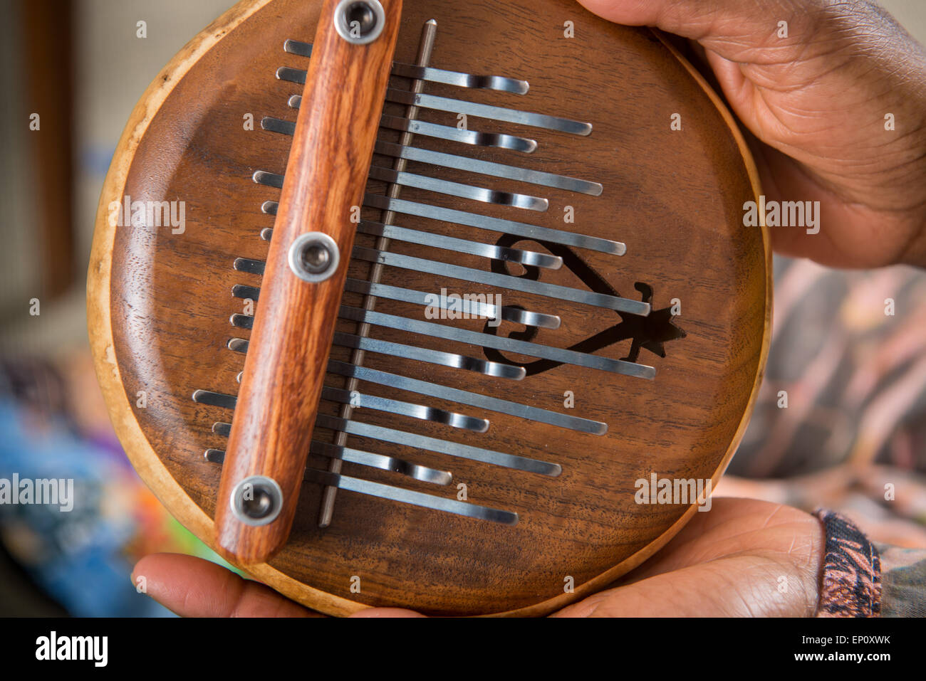 Closeup of African American hands holding a lamellophone musical