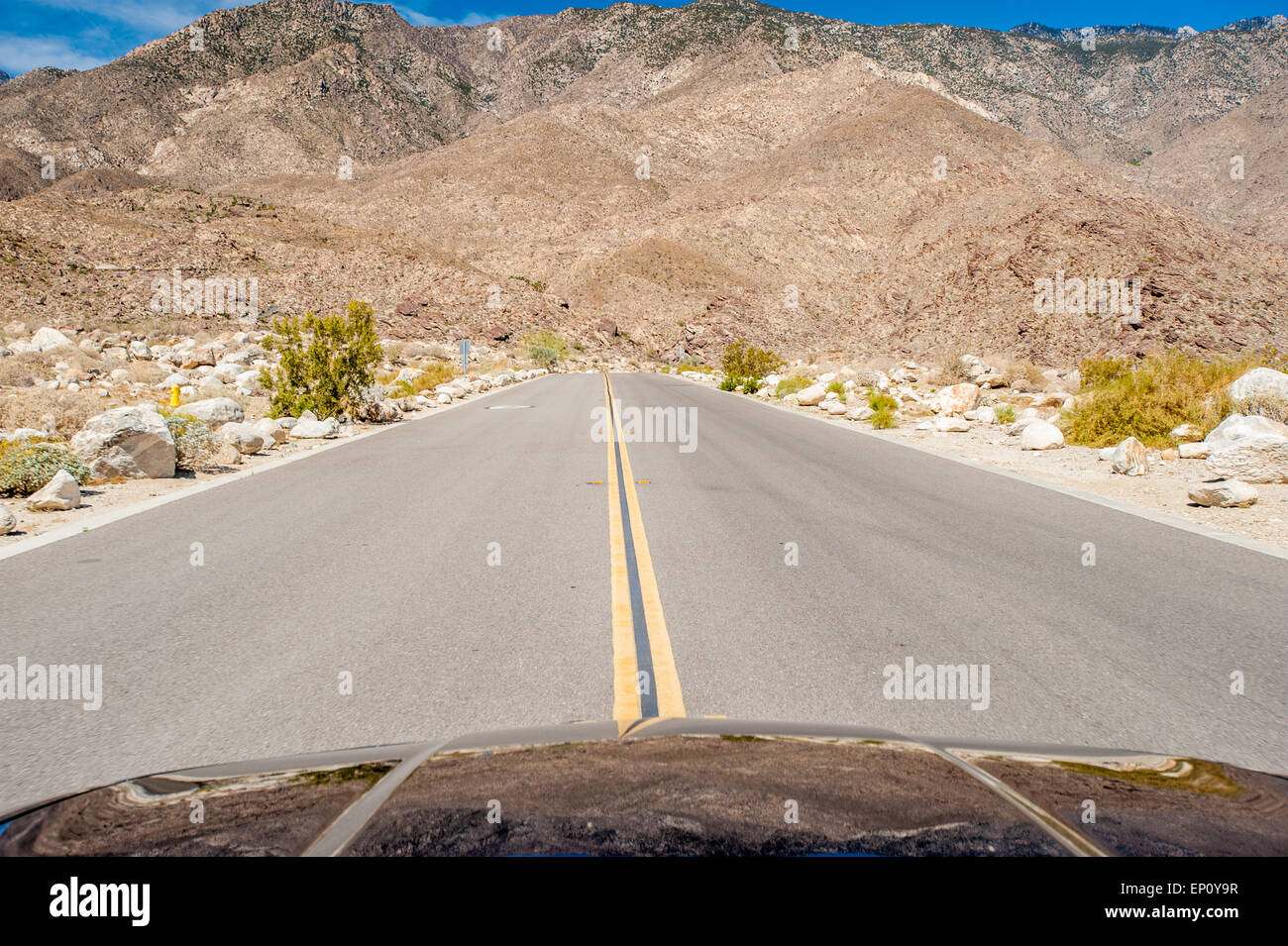 Front of car and middle of a road near Palm Springs, California Stock Photo