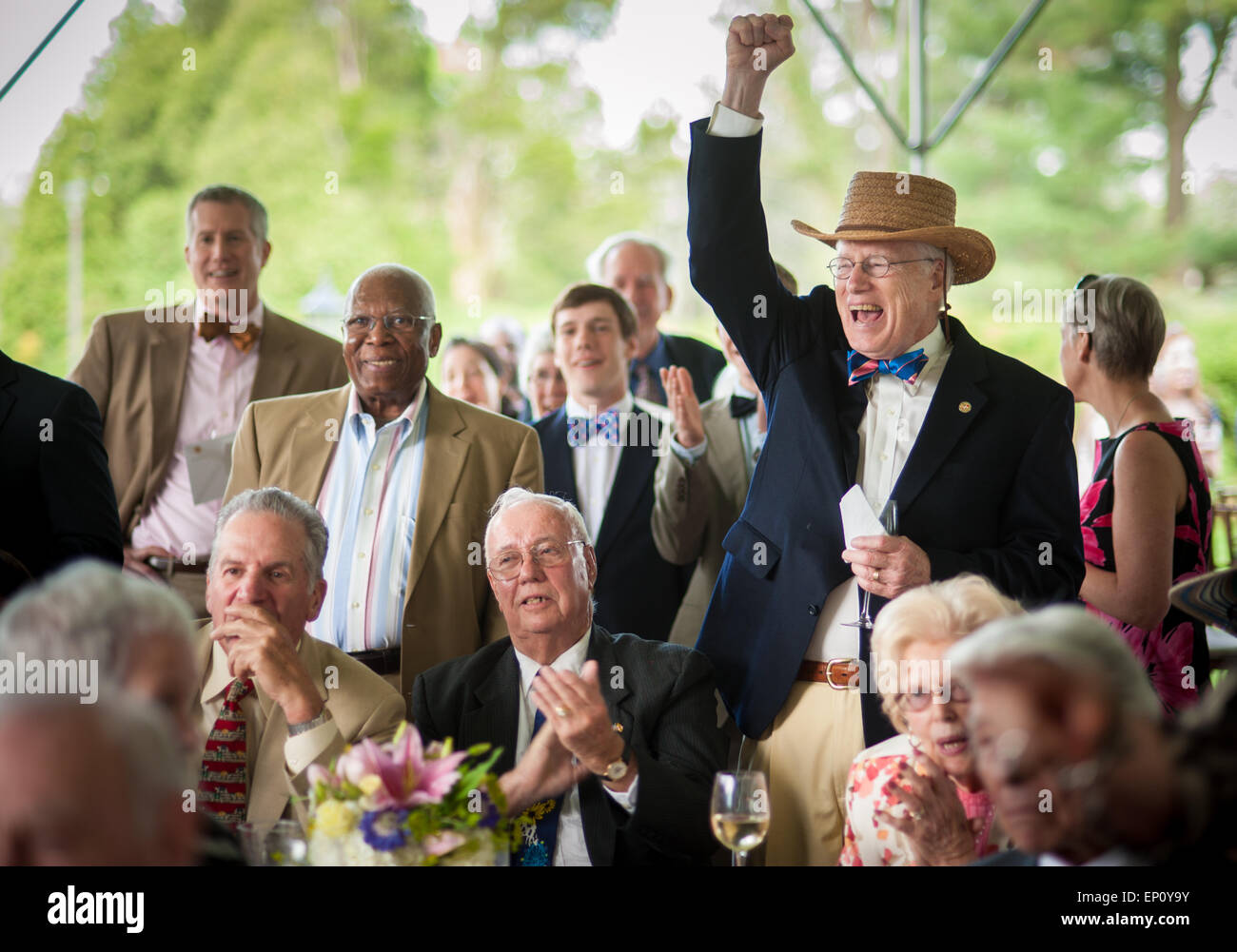 Men cheering while watching horse racing in Baltimore County, MD USA Stock Photo