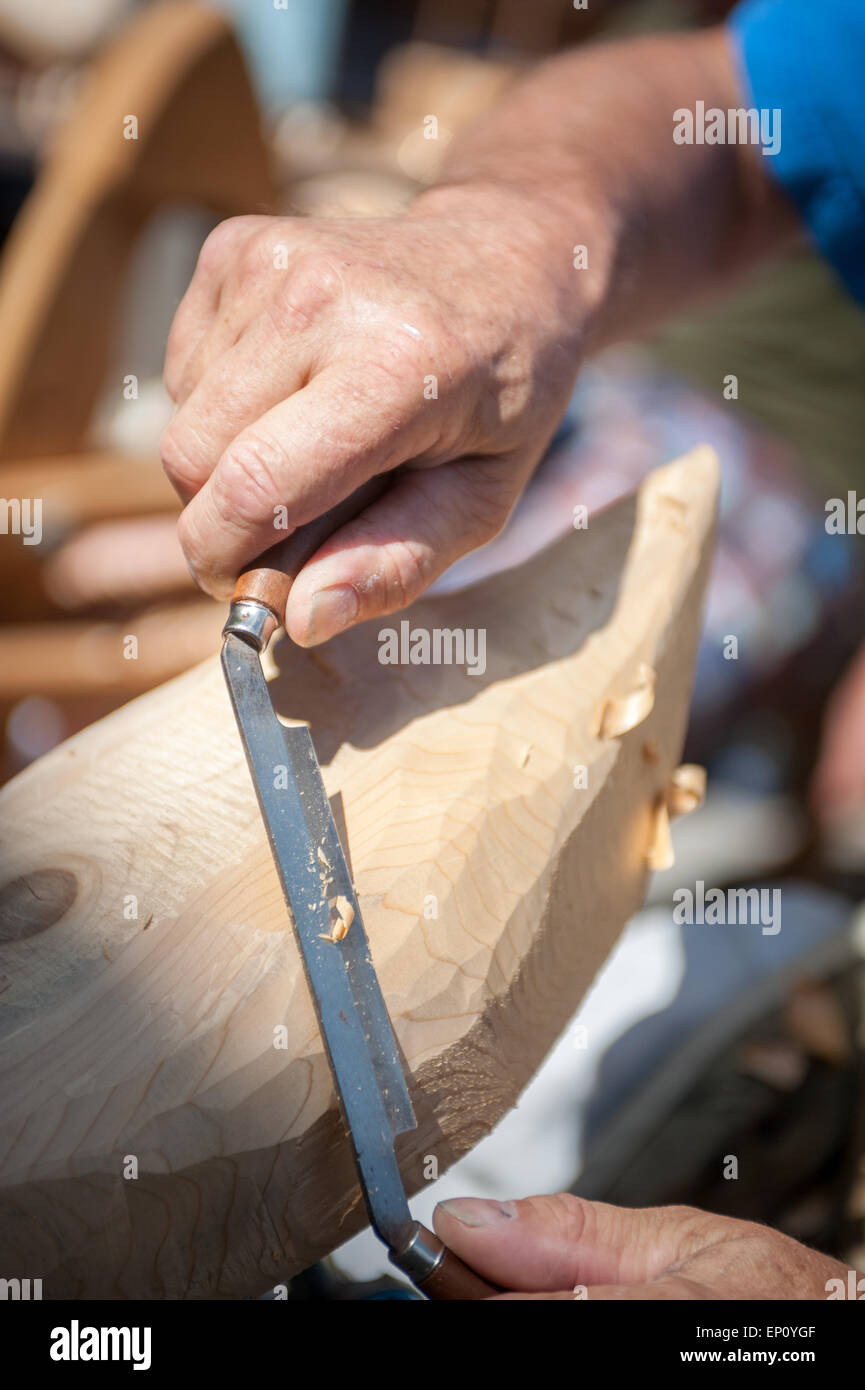 Hands using a spoke plane to carve a wooden duck decoy in Baltimore, Maryland, USA Stock Photo