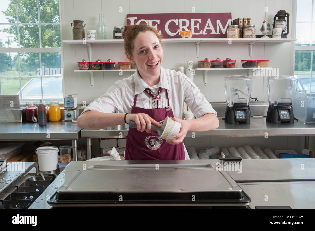 Young woman serving ice cream in Baltimore, Maryland, USA Stock Photo