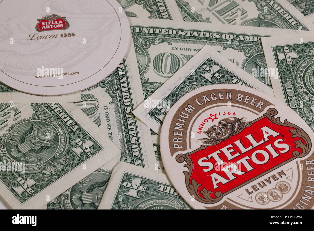 England,London - November 11, 2014:Beermats from Stella Artois and US dollars.It has been brewed in Leuven, Belgium, since 1926. Stock Photo