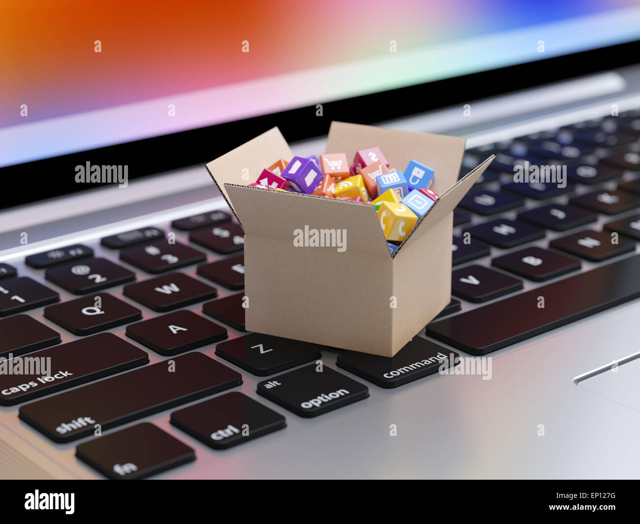 App icons and buttons for smartphone and tablet computer in cardboard box on the laptop keyboard. Mobile applications software a Stock Photo
