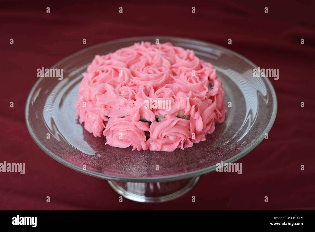 Deliciously Decorated Pink Rose Frosting Cake On A Glass Plate Stock Photo