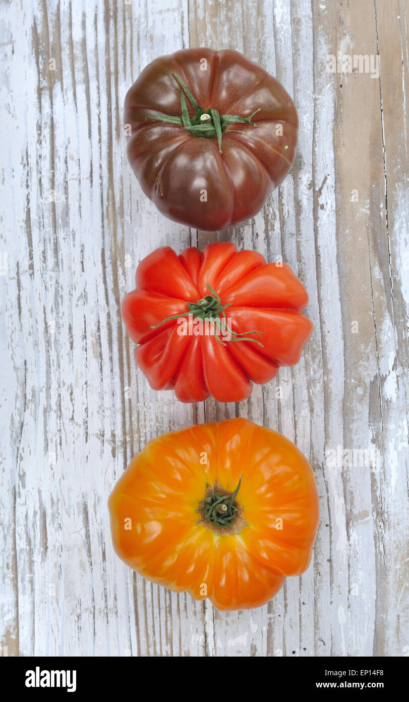 three ancient tomatoes variety on wooden table Stock Photo - Alamy