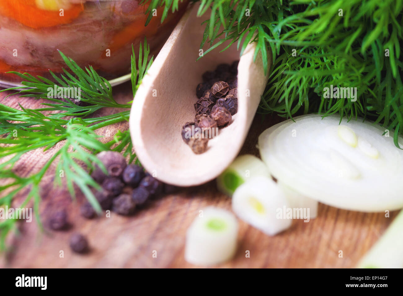 Aromatic herbs, peppers and onions on a table, close-up Stock Photo